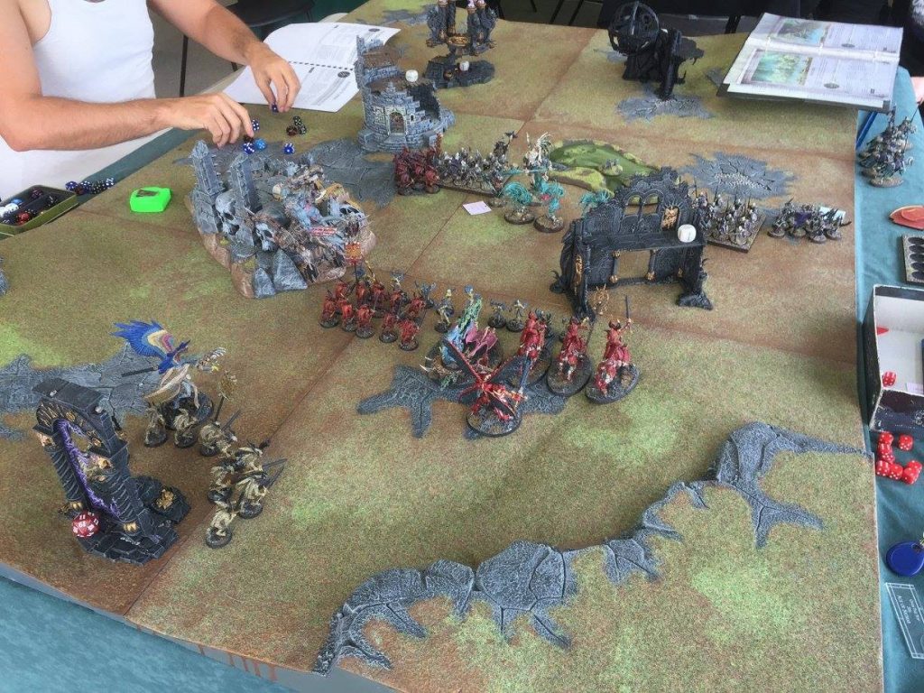 Painted miniatures facing off in a tabletop game of Warhammer Age of Sigmar